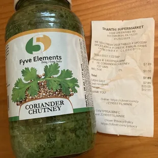 a jar of coriander and a receipt
