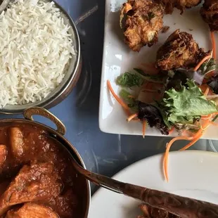 Undeniably spicy chicken vindaloo and basmati rice. The vegetable pakoras pack a lot of flavor.