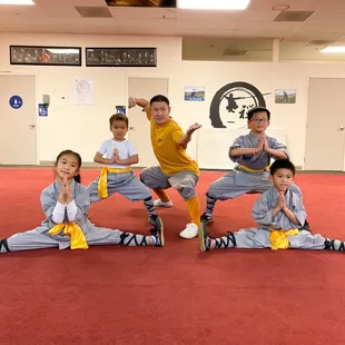 Kids posing for photos after getting their yellow belt