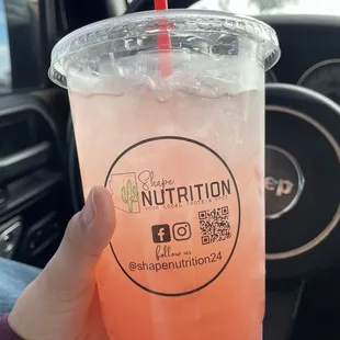 a person holding a drink in their hand