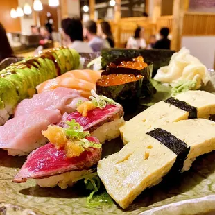 Nigiri / Dragon Roll - Toro, Ikura, Tamago, Salmon Belly  paired with a Dragon Roll.