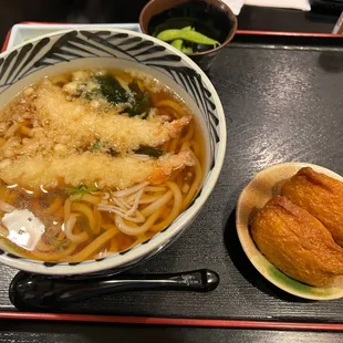 a bowl of noodles and a plate of bread