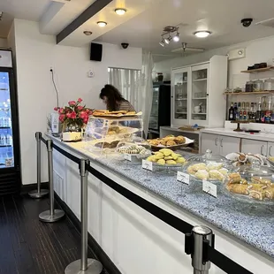 a counter with a variety of pastries on it