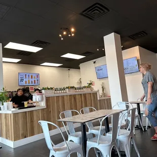 a woman standing at a counter in a restaurant