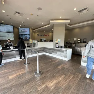two people standing in a coffee shop