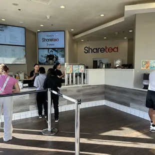 a group of people standing at a counter