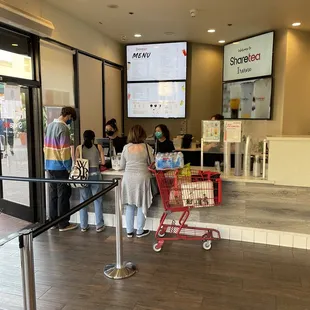 a line of people waiting in line at a store