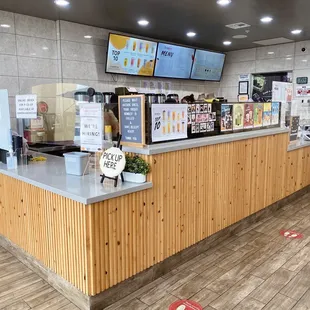 a restaurant with a counter and a tv