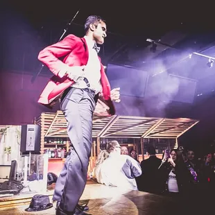 a man in a tuxedo on stage