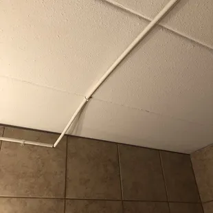 Wrong type of conduit used and not completely tacked to ceiling or wall.