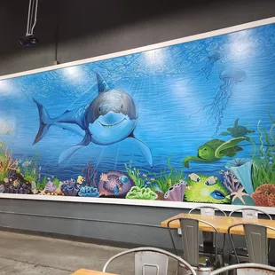 Wall of epicness, who doesn't enjoy eating a burger while watching a great white stare back at you? Family and I always enjoy seeing it.