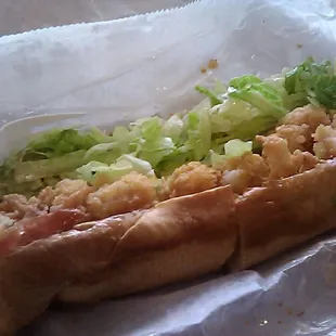 Close up of the fried shrimp poe boy with the onions that I asked to exclude Notice the onions on the paper that I spit out...