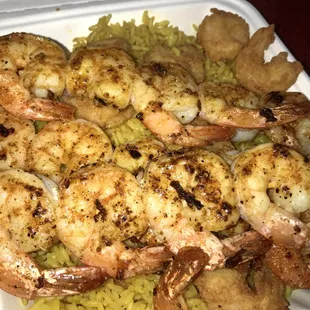 Grilled shrimp over rice.