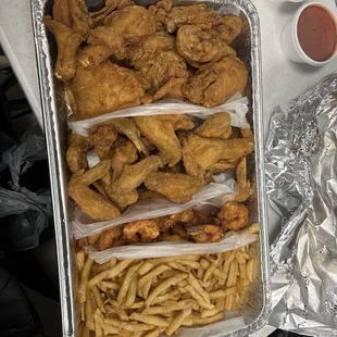 a tray of fried chicken and french fries