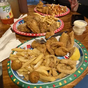 Seafood combo, wings and fried shrimp platter in the back. Mmmmmm mmmmmm