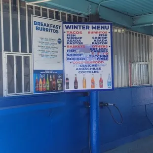 a blue building with a sign on it