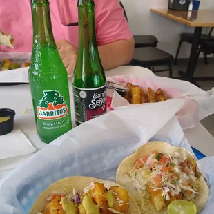 Fish taco, shrimp taco, fried zucchini, and Mexican sodas.