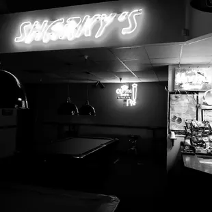 a pool table and neon sign