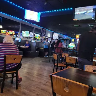 people sitting at tables in a restaurant