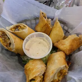 a plate of food with dipping sauce