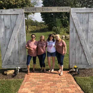 three women standing in front of a gate