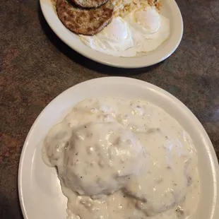 Biscuits and gravy with eggs, hash browns and sausage.