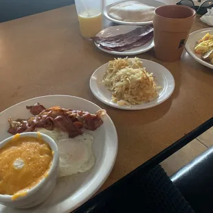 Cheesy grits, delicious biscuit, Eggs over easy and hashbrowns for me and scrambled eggs and home fries for him! Fresh Juice and Coffee too!