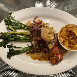 Marinated Rib Eye Steak with Garlic Lobster Tail topped with Colossal Shrimp, 7 cheese Mac &amp; Cheese, Grilled Asparagus and Broccolini
