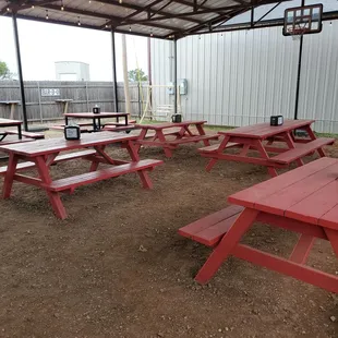 a red picnic table in the shade