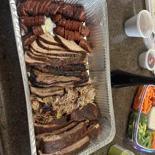 a platter of meat and vegetables