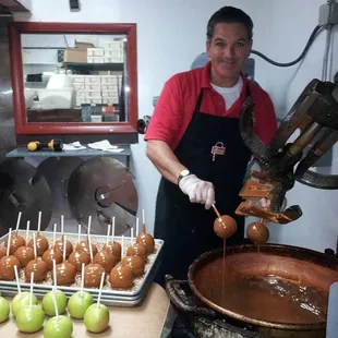 a man making caramel apples