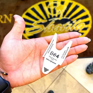 a hand holding a piece of paper