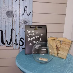 Guest book of well wishes on Jenga pieces in entryway.