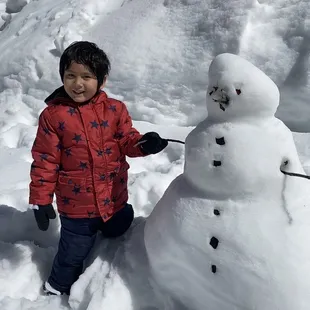 My son building a Snowman