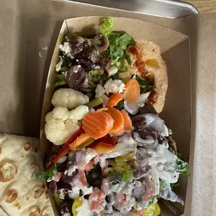 Beef gyro bowl over rice with all of the toppings with a side of spicy hummus and a greek salad.