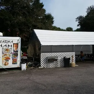 My mom happily waiting under the tent for her first falafel from here!