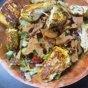 Fatouch salad topped with chicken shawarma