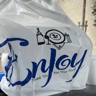 a plastic bag with the word enjoy on it