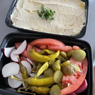 Hummus and side pickles and veggies