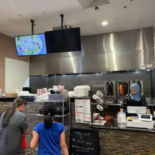 a woman and a woman behind the counter