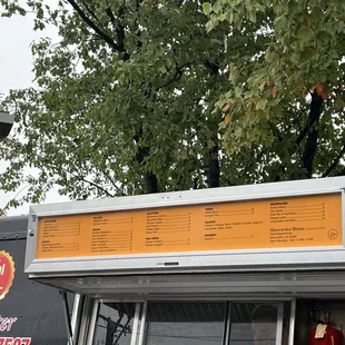 a food truck parked in front of a tree
