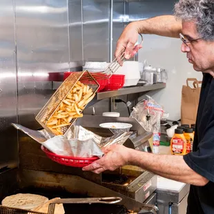 a man preparing food in a kitchen