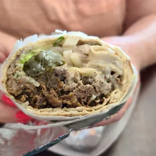 Inside of a beef shawarma wrap, big sandwich with lots of meat