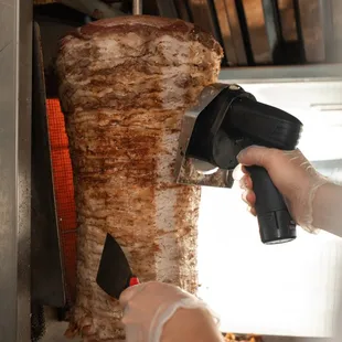 a hand holding a meat spatula