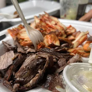 a plate of meat and fries