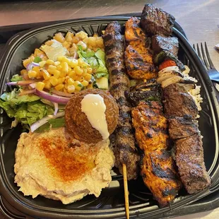 Combo Kabob Plate (kafta, chicken, beef) side of Baba Ghanouj, salad, Spiced Potatoes, brown rice.