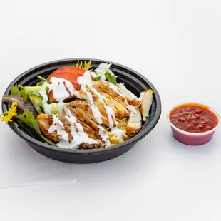 Marinated chicken in our house spice mix, served on a bed of basmati rice, spring mix &amp; our signature white sauce &amp; optional hot sauce.