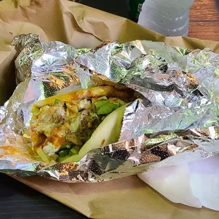a sandwich wrapped in aluminum foil