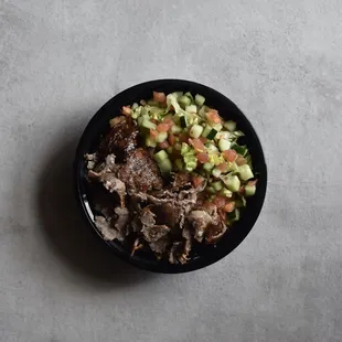 an overhead view of a bowl of food