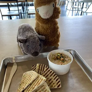 a stuffed animal and a bowl of soup